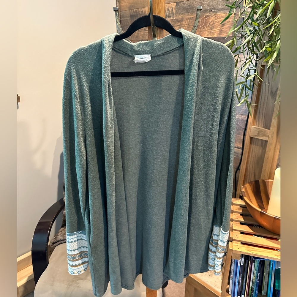 Boutique sweater with patterned sleeves. Good used condition.